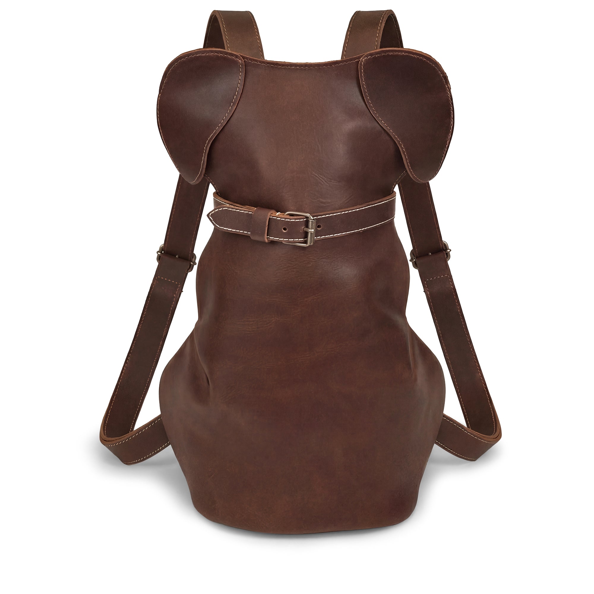 The Doggy-Shaped Backpack by Hide & Play is a stylish leather bag featuring cute dog ears, perfect for pet lovers. This unique Leather Dog-Shaped Backpack is a fun carryall made of full grain leather, showcasing artisan craftsmanship with its hand-cut and hand-sewn design, handmade in La Antigua Guatemala & Oaxaca Mexico.