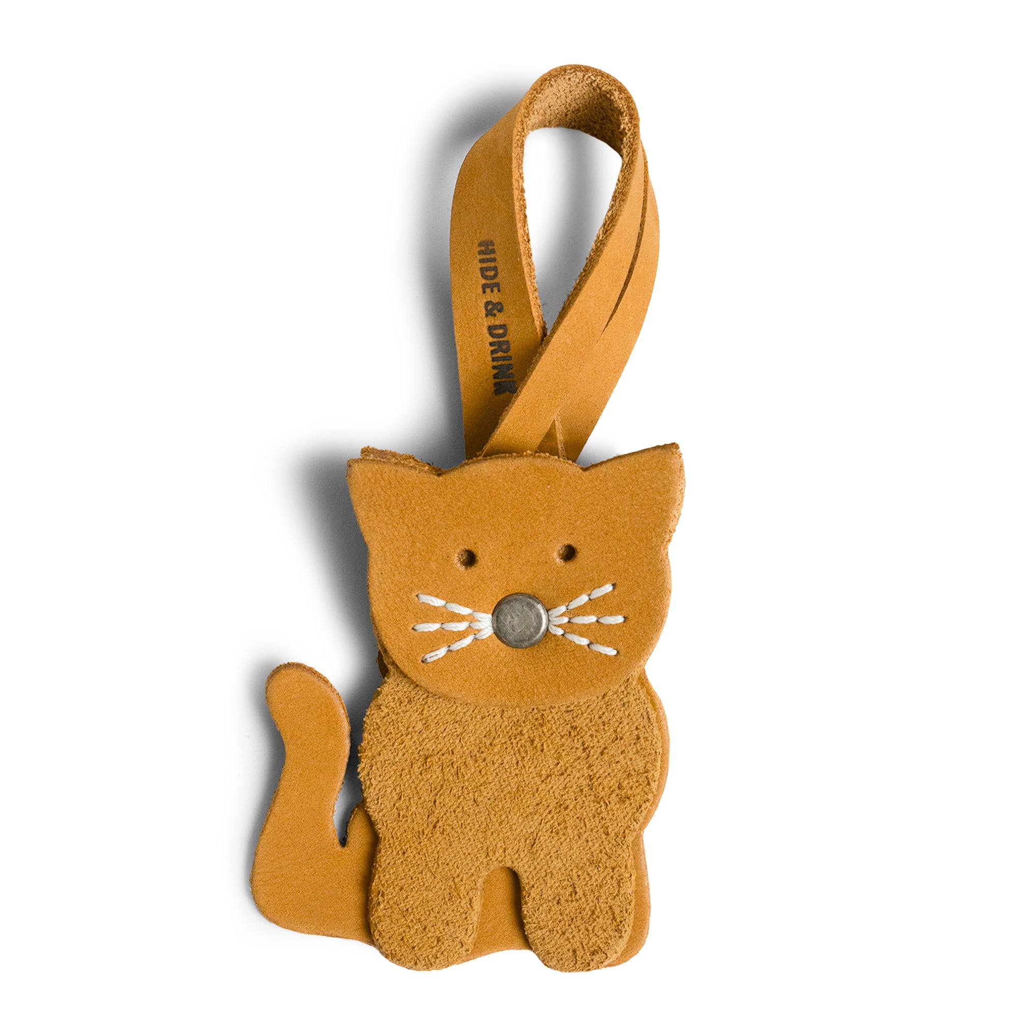 Hide & Drink Bag Charms showcasing a lovely cat design, the perfect charm for handbags. This accessory serves as a purse charm for tote & backpacks crafted from high-quality full grain leather. Every piece highlights StockyardX's small batch production approach with hand cut, hand sewn craftsmanship and fire branding, handmade in La Antigua Guatemala & Oaxaca Mexico.