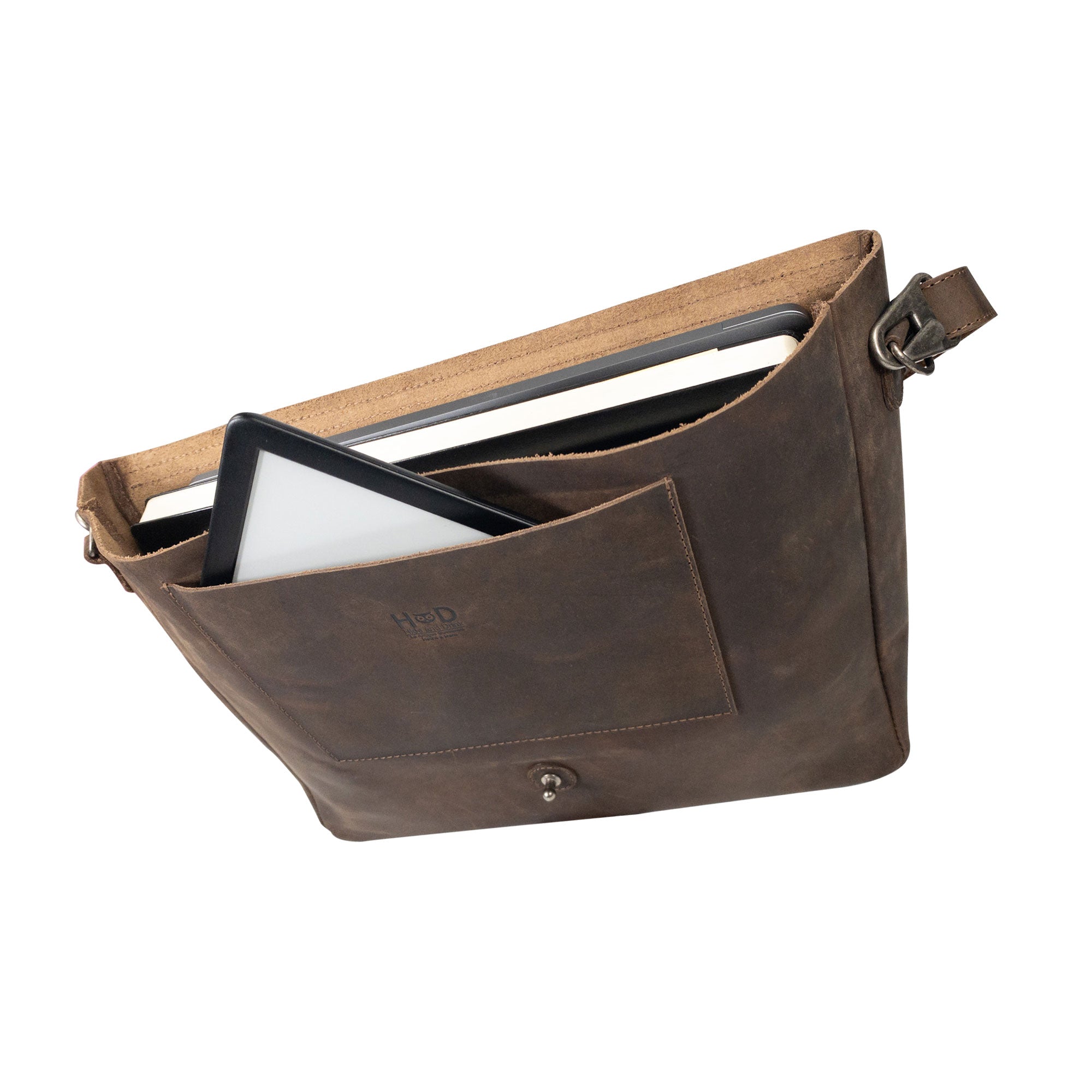 Interior view of Hide & Drink's Messenger Bag with Adjustable Strap, showing spacious storage for laptops and essentials. This travel accessory includes a messenger bag with shoulder strap made from full grain leather, combining artisan craftsmanship with small batch production, hand cut, and hand sewn details. Handmade in La Antigua Guatemala & Oaxaca Mexico.