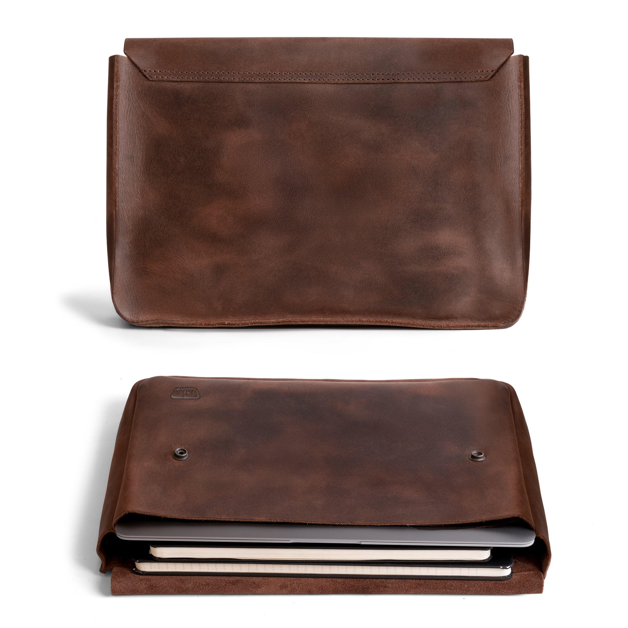 Leather Worx Folder Document Holder displayed in a stylish manner, made from durable full grain leather. This vintage folder document holder functions as a file case, ideal for organizing documents, serving as an office and work essential. Each piece is artisan-crafted in La Antigua Guatemala, showcasing small batch production methods, hand cut and hand sewn details, and fire branded finishing.