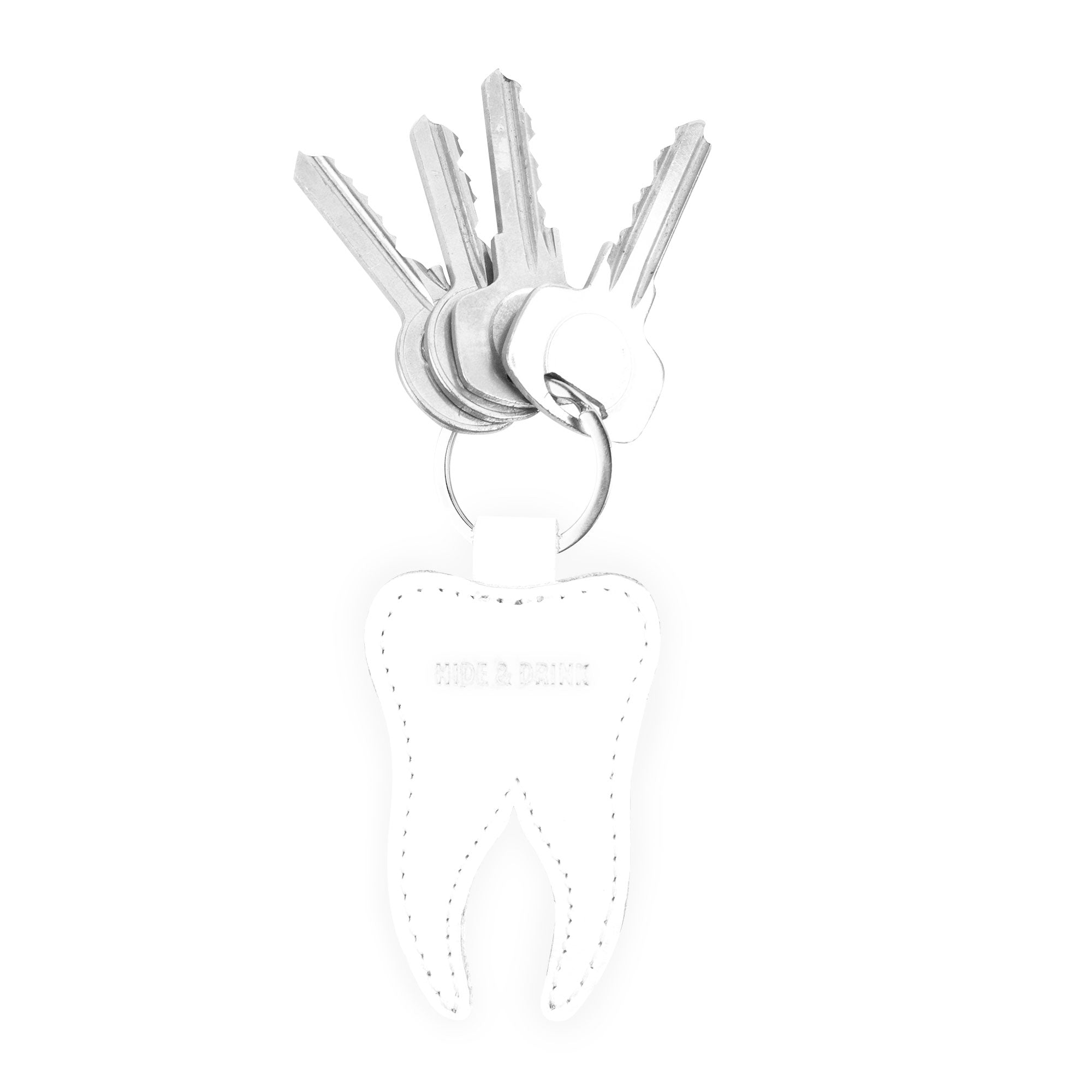 Tooth Keychain by Hide & Drink featuring a fun tooth design, perfect for dental professionals. This Tooth Leather Keychain is a unique key ring made from full grain leather, showcasing artisan craftsmanship. Ideal as dentist gifts, it represents small batch production, hand cut, hand sewn, and fire branded quality, made in La Antigua Guatemala & Oaxaca Mexico.