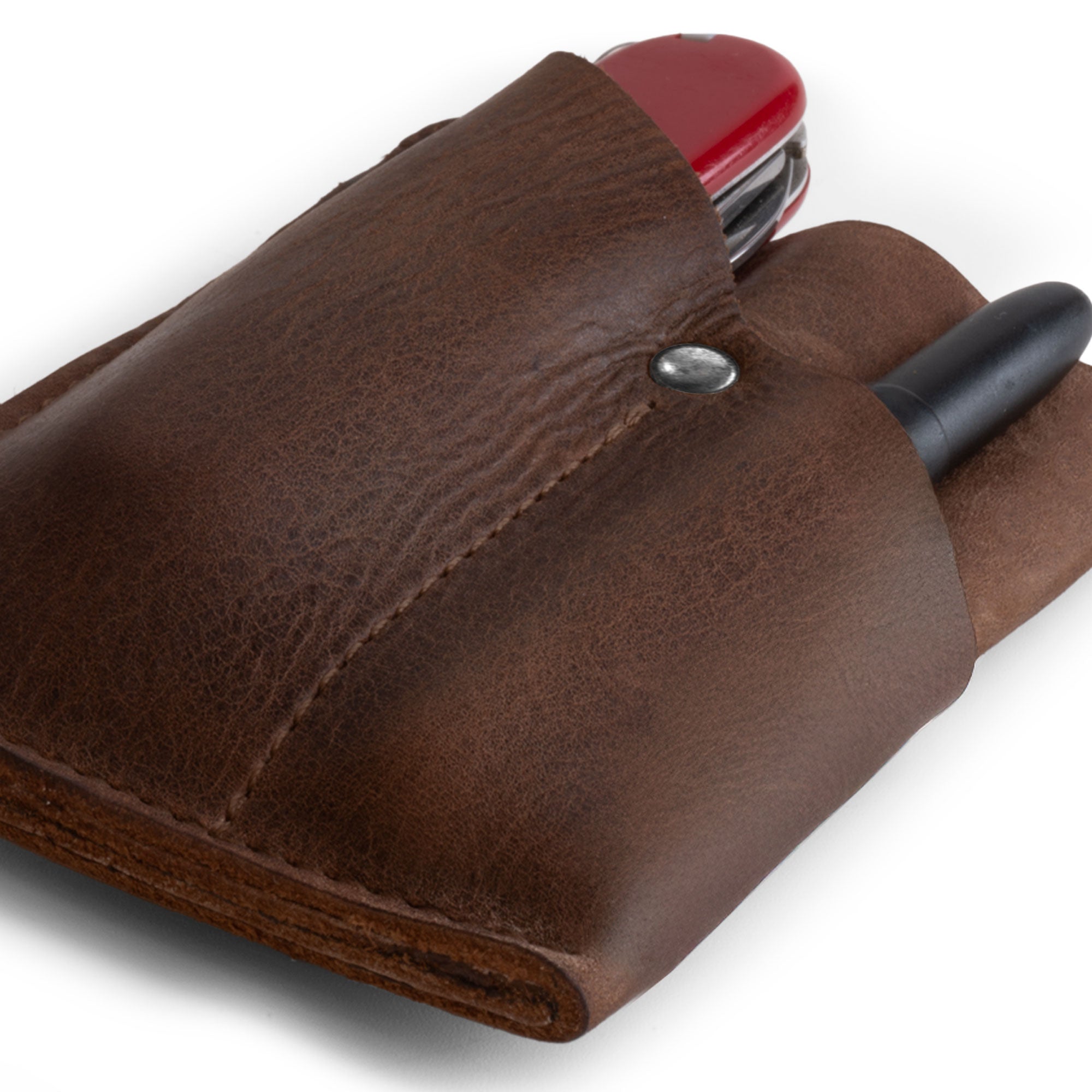 Close-up of the EDC Pocket Wallet by Hide & Drink, displaying its practical design and soft full grain leather finish. This handmade wallet acts as a multitool pouch, card holder, and money organizer, ideal for travel. Crafted in small batches, it's hand cut, hand sewn, and fire branded in La Antigua Guatemala & Oaxaca Mexico.