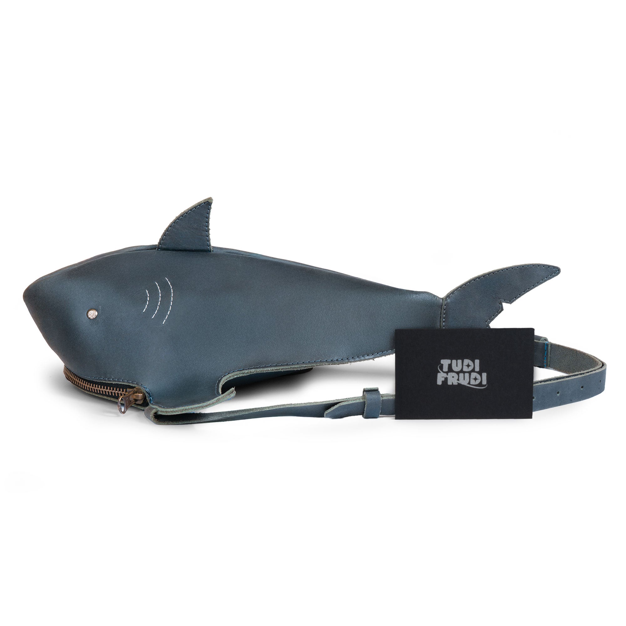 Tudi Frudi's Shark-Shaped Shoulder Bag presented with branding tags, showcasing unique artisan craftsmanship. This eye-catching Crossbody Shoulder Messenger Bag made from full grain leather, emphasizes its handmade quality, crafted in La Antigua Guatemala.