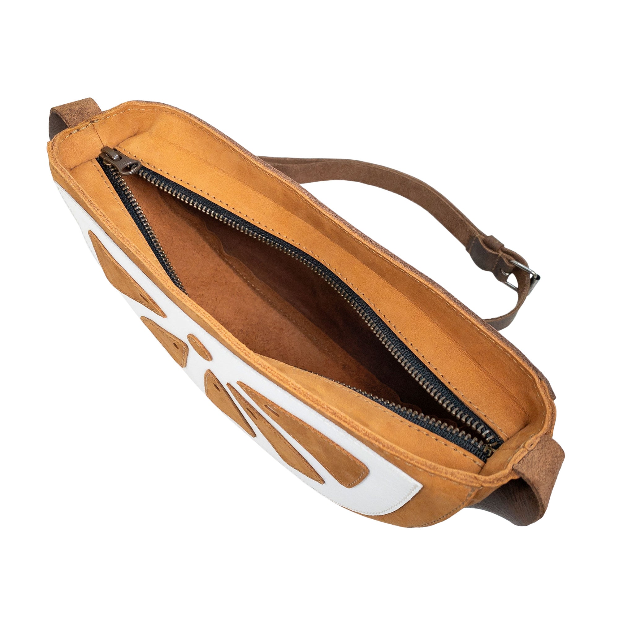 Top view of the Lemon-Shaped Shoulder Bag by Tudi Frudi, showing the zipper compartment for secure storage. This Lemon-Shaped Shoulder Bag with Adjustable Strap is ideal as a Messenger Bag and Vintage Purse. It features Full Grain Leather and is made through Small Batch Production, hand cut and sewn by talented artisans in La Antigua Guatemala & Oaxaca Mexico.