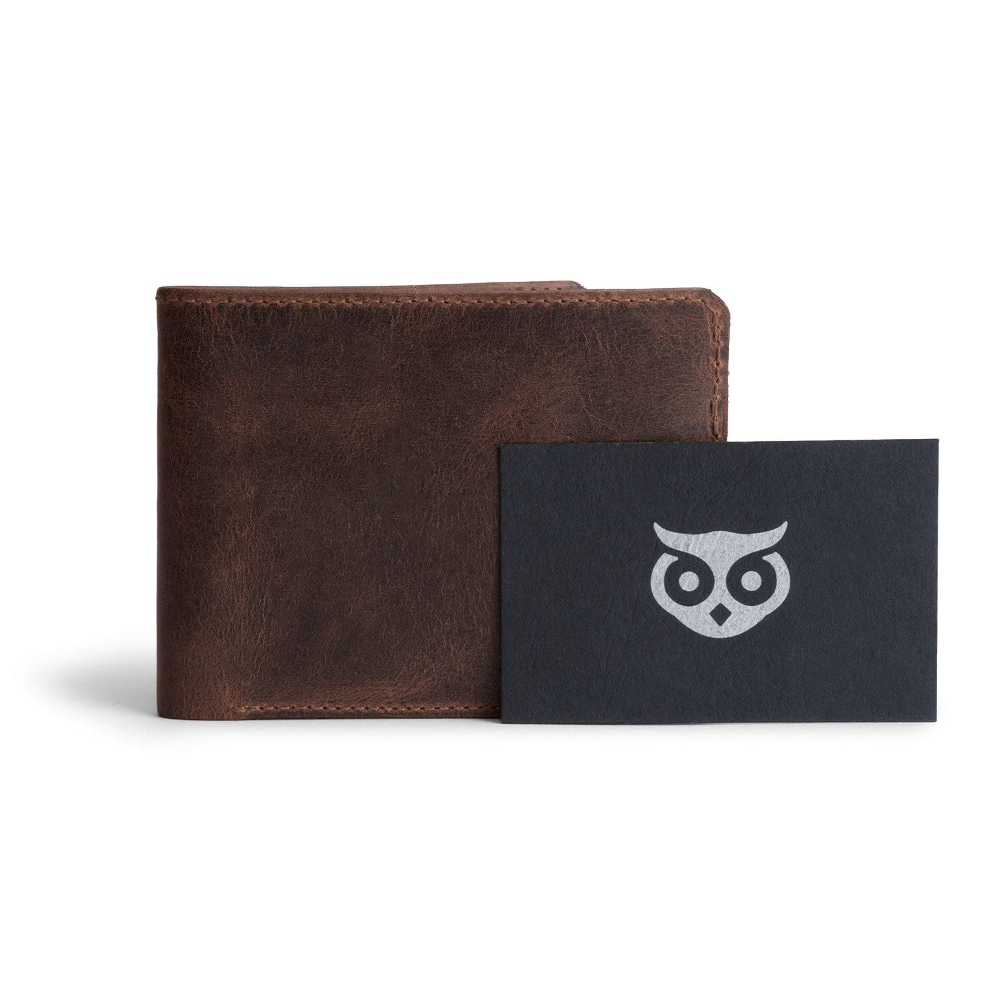 Hide & Drink’s Bifold Wallet alongside the Stockyard Exchange card, highlighting the artisan craftsmanship. This Slim Bifold Wallet serves as a classic billfold for your pocket or bag, adept at storing cash and cards, making it a wonderful travel accessory, handcrafted from full grain leather in La Antigua Guatemala & Oaxaca Mexico.