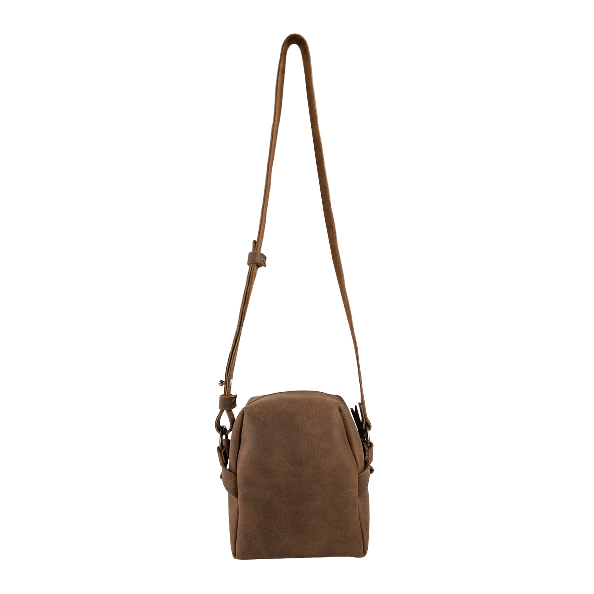 Side view of Heather's Cube Shaped Bag featuring an adjustable shoulder strap. This Cube Shape Bag is a unique Rustic Satchel, ideal as a Handbag or Purse crafted from luxurious Full Grain Leather. It represents StockyardX’s focus on Small Batch Production, showcasing expert Hand Cut and Hand Sewn details, Fire Branded for quality assurance, and is Handmade in La Antigua Guatemala & Oaxaca Mexico.