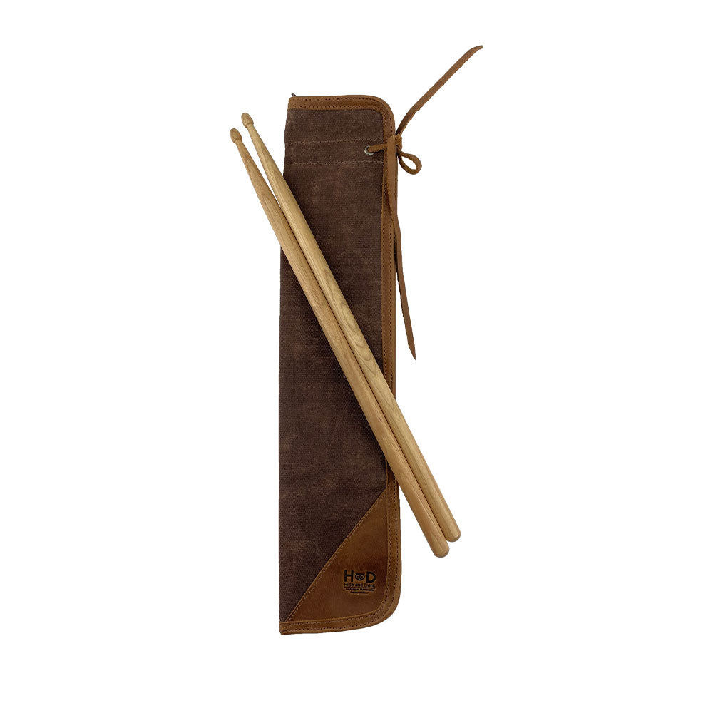 Close-up view of the brown Hide & Drink Drummstick Bag highlighting its zipper and durable materials. This Waxed Canvas & Full Grain Leather Drumstick Bag Holder is ideal for drummers, representing the artisanal craftsmanship from small batch production in La Antigua Guatemala & Oaxaca Mexico.