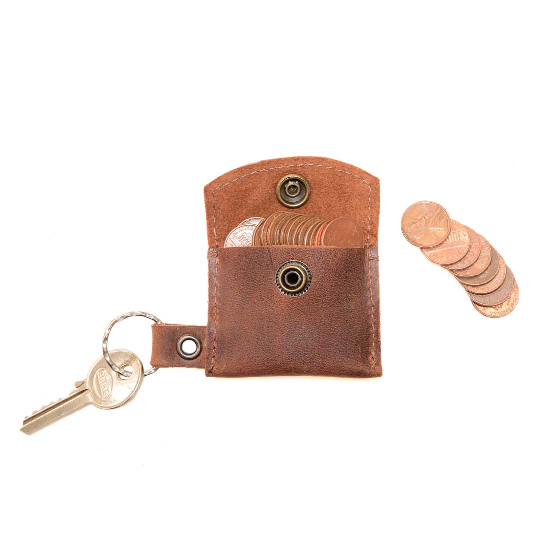 Close-up of Tiny Coin Holder Keychain by Hide & Drink, showcasing its functionality with coins and key access. Made from Full Grain Leather, this Tiny Coin Holder is a testament to small batch production and artisan quality, hand-cut and fire branded.