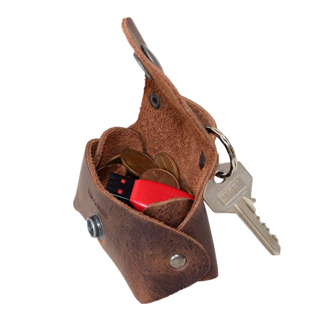 Inside view of the Tiny Handbag Keychain, showcasing its spacious design with key ring holder, crafted from full grain leather by Hide & Drink. This practical Tiny Handbag with Key Ring Holder offers a blend of small batch production, hand cut, hand sewn, and fire branded craftsmanship, artisan-made in La Antigua Guatemala & Oaxaca Mexico.