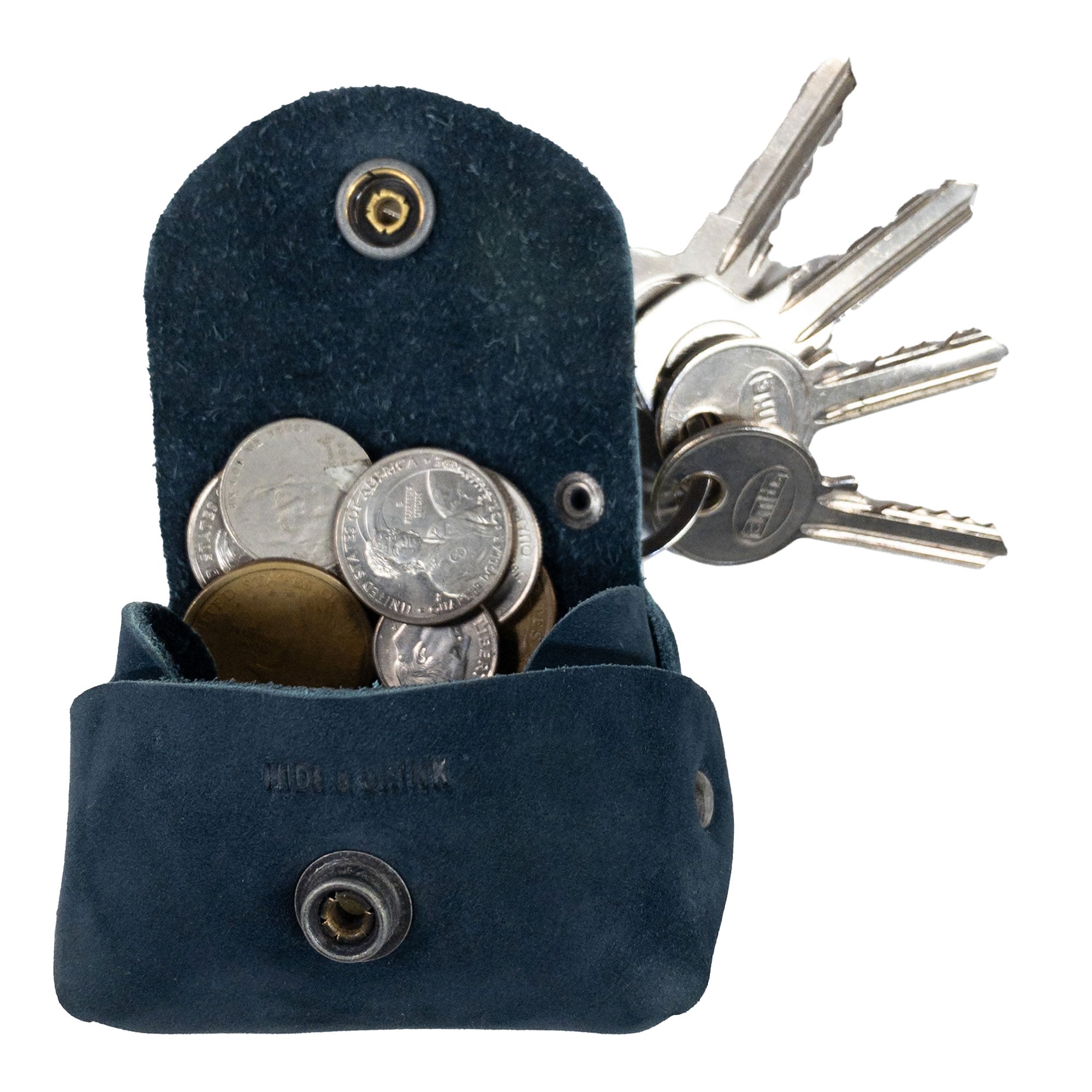 Inside view of the Tiny Handbag Keychain by Hide & Drink, displaying its storage for coins and keys. This Tiny Handbag with Key Ring Holder is crafted from Full Grain Leather, highlighting its small batch production, hand cut and hand sewn details, fire branded, and handmade in La Antigua Guatemala & Oaxaca Mexico.