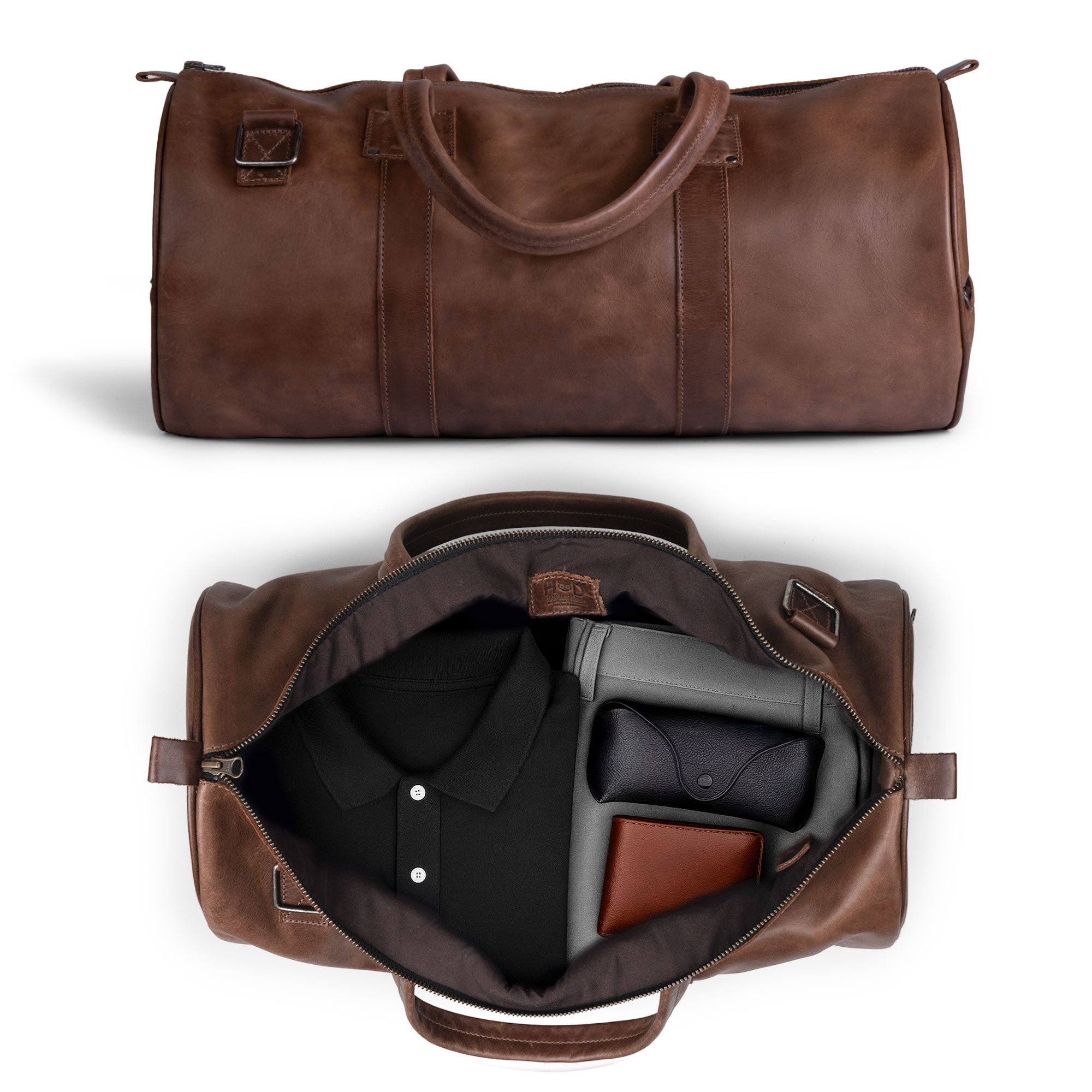 An open view of the Classic Duffle Bag by Hide & Drink, featuring spacious interior storage ideal for travel. This Full Grain Leather Classic Duffle Bag includes an adjustable strap and zipper closure, making it a perfect Messenger Bag and crossbody travel bag, crafted by artisans in La Antigua Guatemala & Oaxaca Mexico.