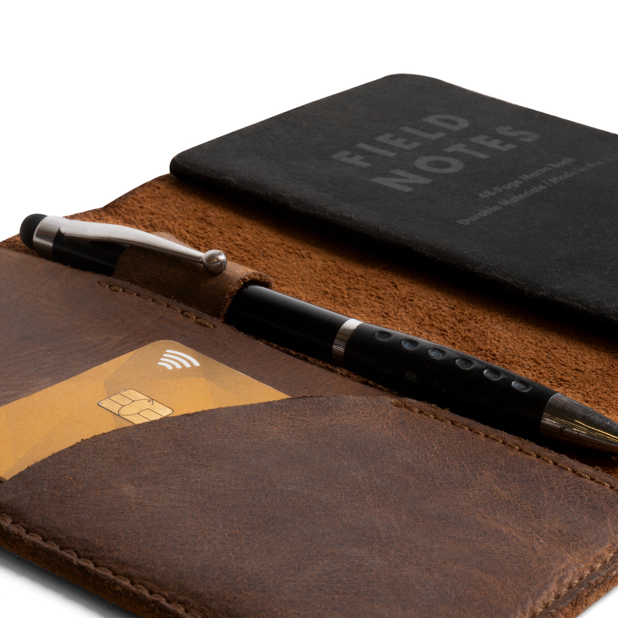 Close-up of the Field Notes Carrier's interior, showing the card pocket and pen holder by Leather Worx. This Field Notes Cover is designed as a Leather Notebook Cover 3.5 x 5.5 in. for practical use. A handy companion for travelers, it is made from premium full grain leather, emphasizing artisan quality and small batch production techniques, crafted in La Antigua Guatemala.
