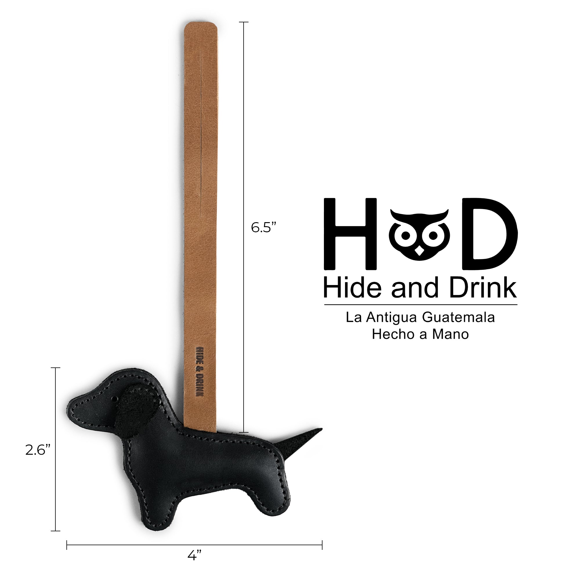 Product dimensions and branding details of the Hide & Drink Dachshund Bag Charm, featuring its stylish design. This Dachshund Bag Charm is not just a handbag ornament but a piece of handmade artistry, crafted from full grain leather in small batch production. Ideal for women seeking unique purse charms, it reflects the handcrafted elegance made in La Antigua, Guatemala and Oaxaca, Mexico.