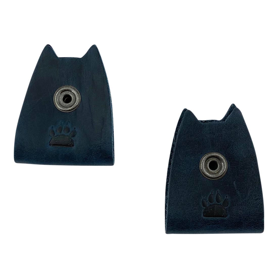 Close-up of navy Taco Dog Cat Cord Keeper (2 Pack) featuring its button closure mechanism. Designed for managing earbuds, headphones, and chargers, keeping them organized. Made with care in La Antigua Guatemala & Oaxaca Mexico.