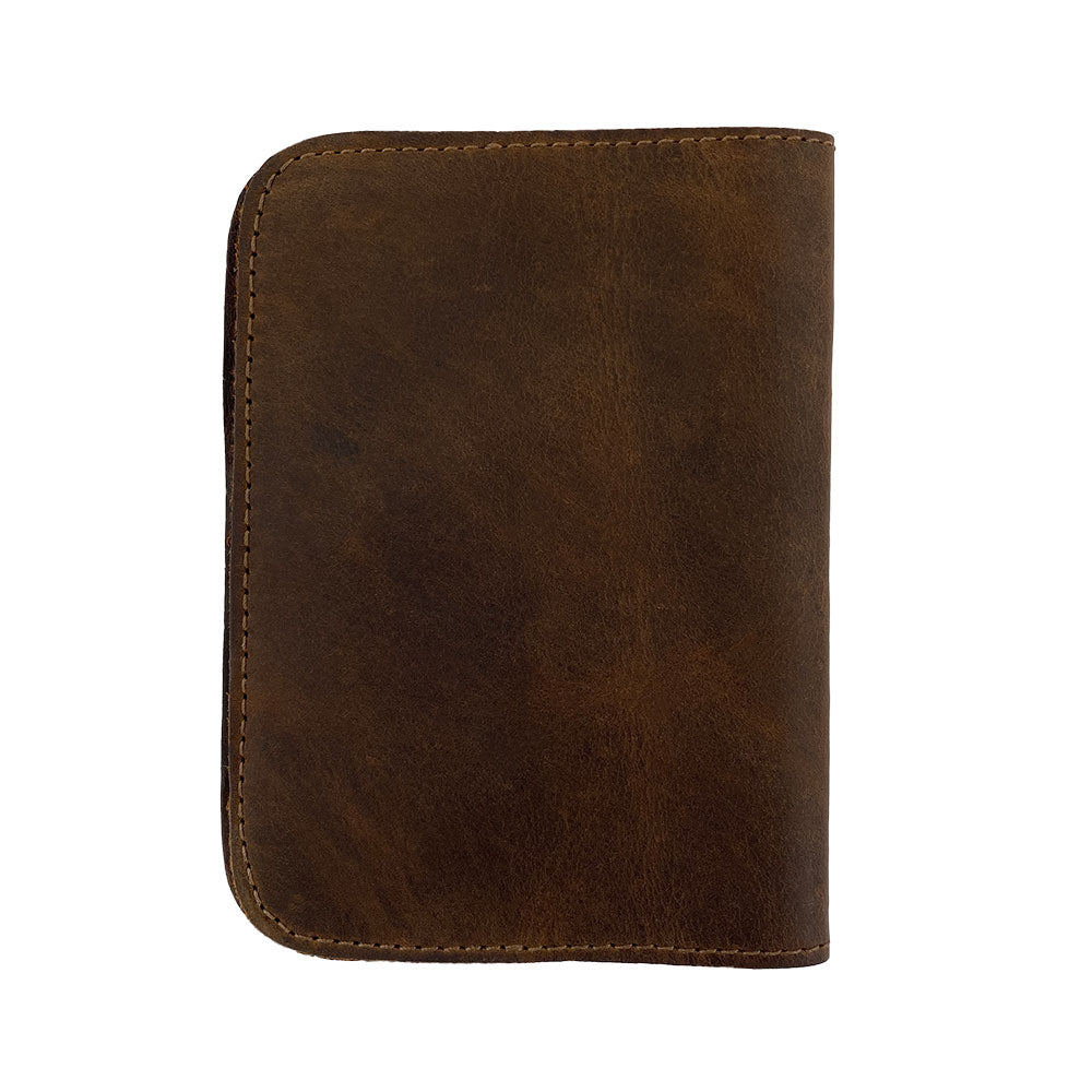 Back view of the Hide & Drink Travel Wallet, featuring a rugged yet elegant design. This travel wallet is perfect for organizing travel accessories, as a bifold passport case crafted from high-quality leather, made in La Antigua Guatemala.