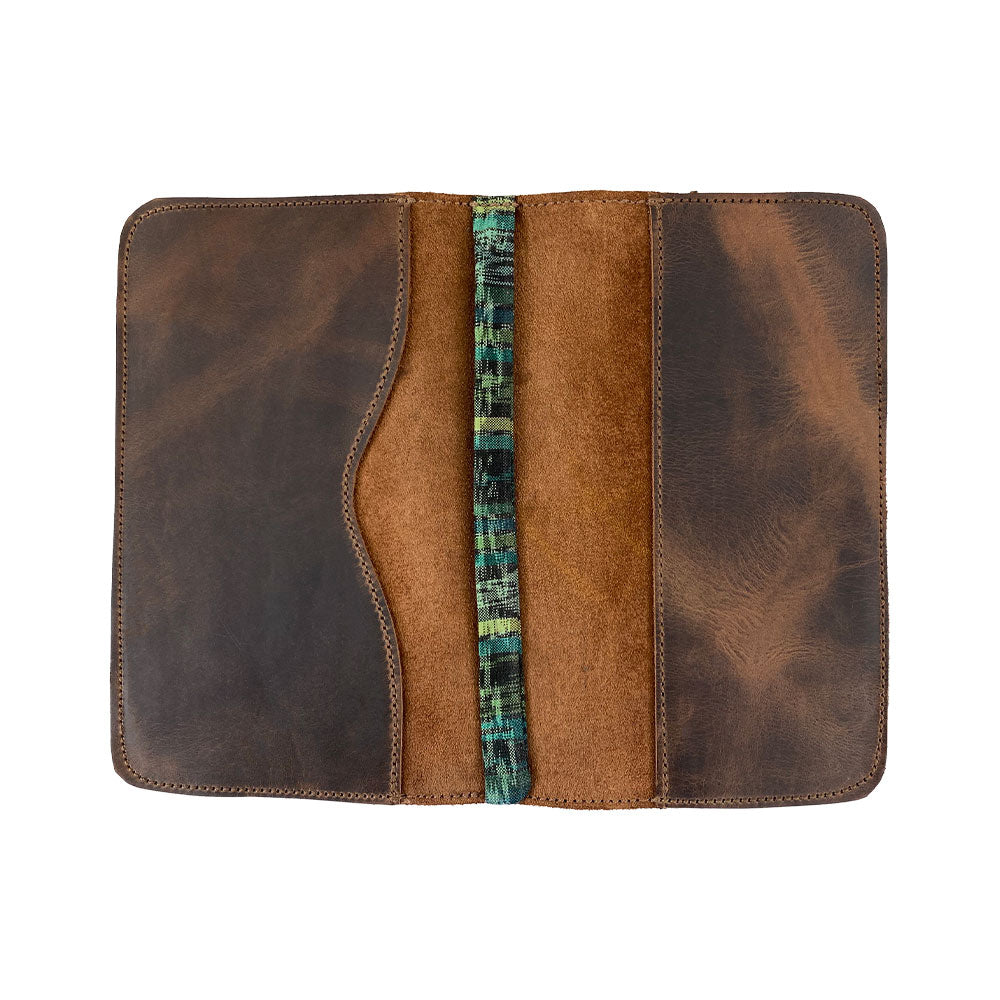 Open view of the Journal Cover for Moleskine Cahier L (5 x 8.25 in.) featuring a refillable design with a strap by Hide & Drink. This rustic protector is handcrafted from full grain leather, perfect for your large size (5 x 8.25 in.) notebook, highlighting small batch production and artisan quality.