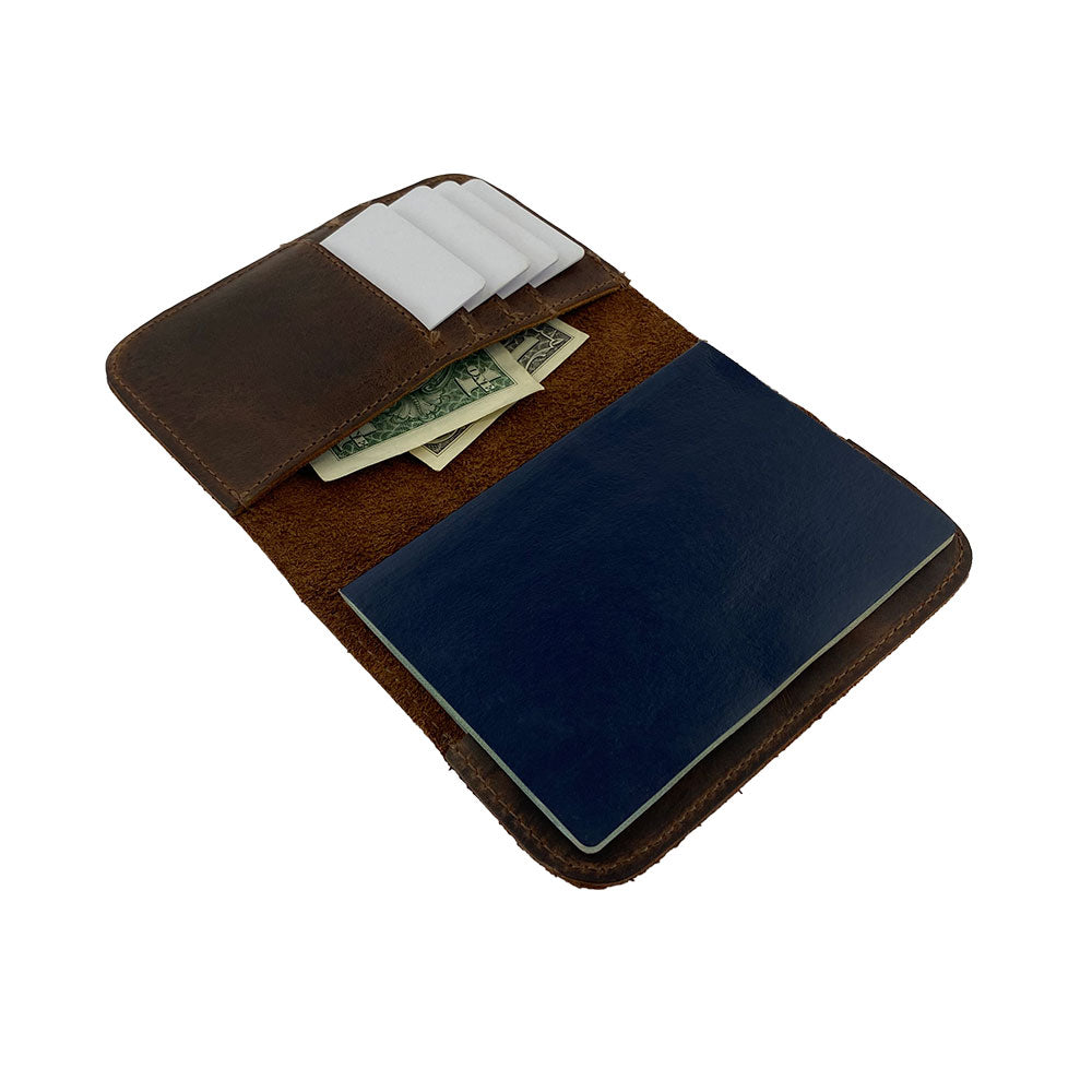 Open view of the Hide & Drink Travel Wallet revealing its inner compartments. This practical and stylish travel wallet is a bifold passport case handmade from full grain leather in La Antigua Guatemala.