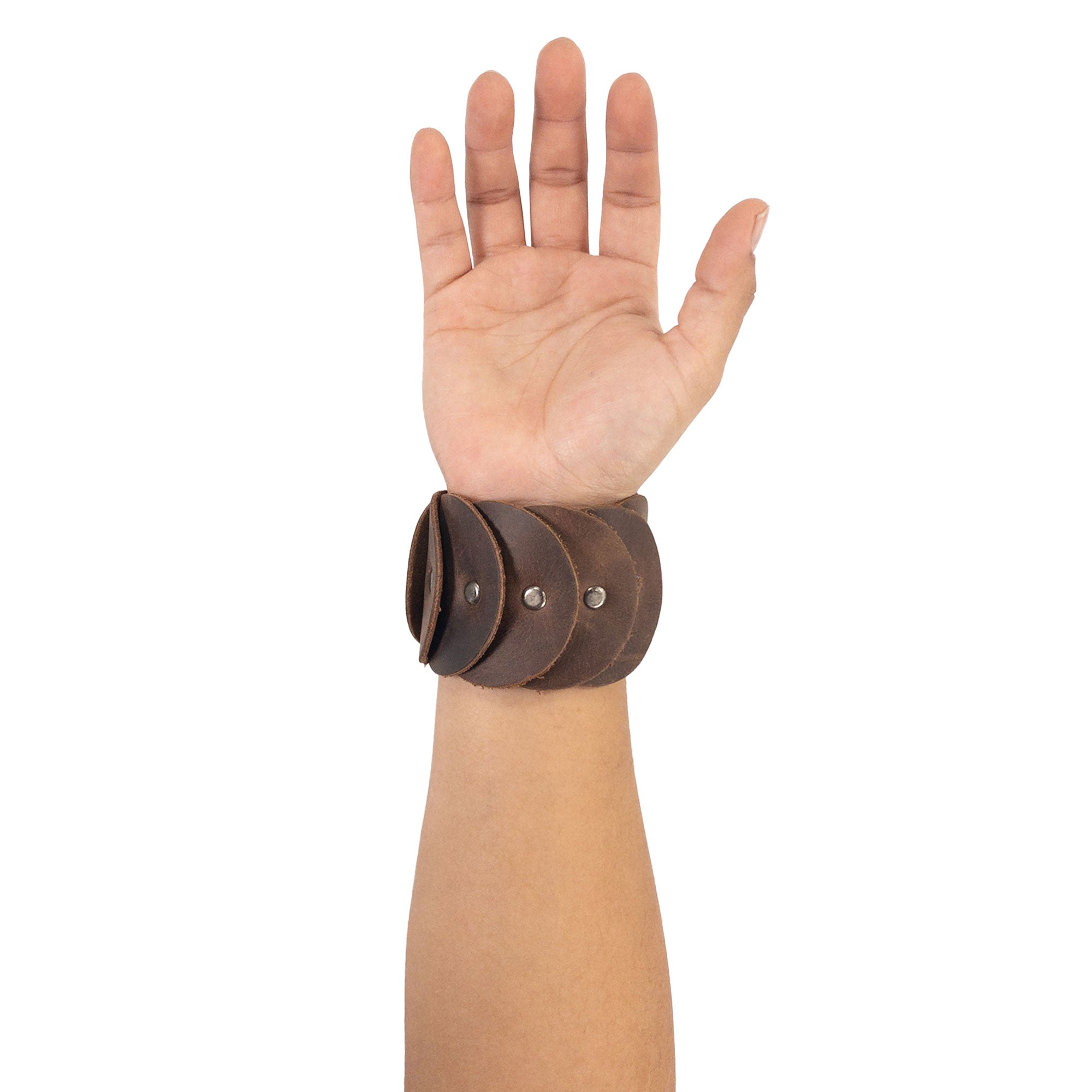 A model wearing the Moon Bracelet by Heather's, made from Full Grain Leather, illustrating its stylish and comfortable fit. This handmade accessory represents Small Batch Production, with meticulous Hand Cut and Hand Sewn details, reflecting the artistry from La Antigua Guatemala & Oaxaca Mexico.