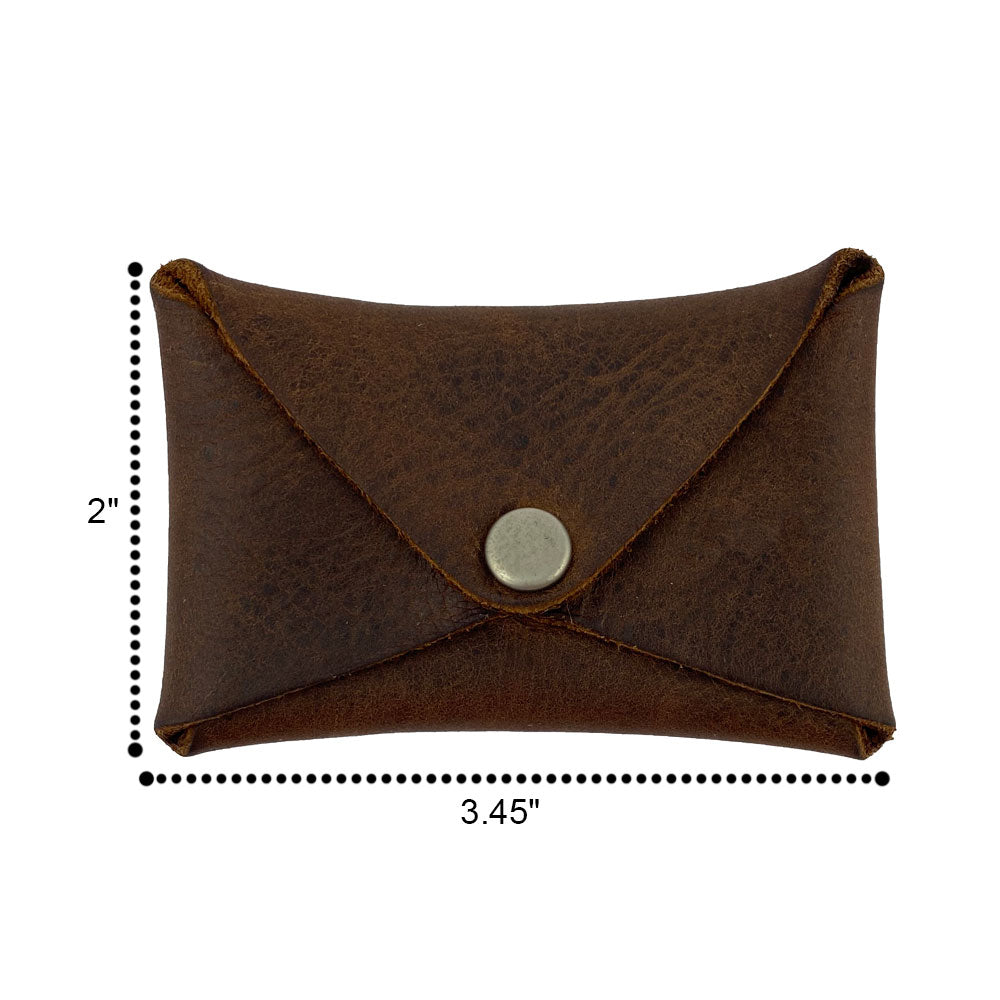 The Hide & Drink Envelope Coin Case shown with dimensions, emphasizing its compact size and rustic leather craftsmanship. An artisan piece made from full grain leather, handcrafted in La Antigua Guatemala & Oaxaca Mexico.